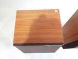 two pieces of wood are stacked on top of each other on a white surface