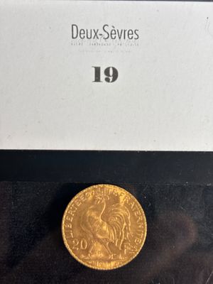 a close up of a gold coin on a black surface