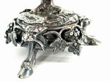 a silver plate with a tree on top of it