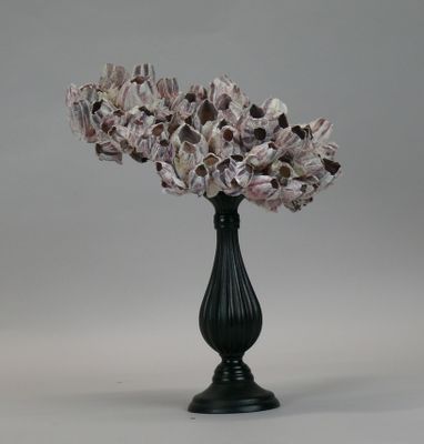 a black vase with a bunch of flowers inside of it