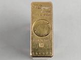 an image of a gold bar with a smiley face on it