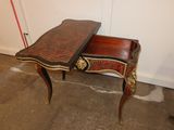 a small desk with a drawer on it in a room