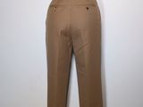 brown pants on a mannequin stand against a white wall