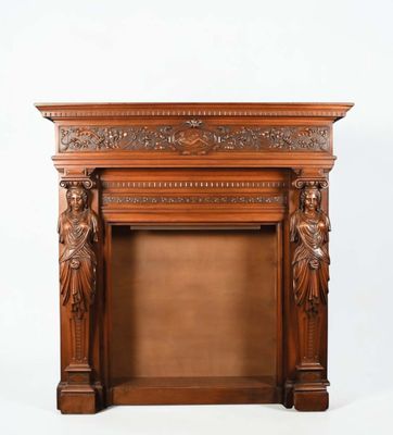 an image of a wooden fireplace with carvings on the mantle
