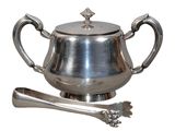 a silver teapot and spoon on a white background