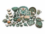 many pieces of pottery that are sitting on a white surface