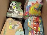 a cardboard box filled with assorted children ' s luggage