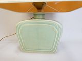 a green lamp that is sitting on a table