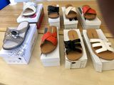many pairs of sandals that are on a table