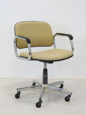 an image of a yellow office chair sitting on top of a white floor