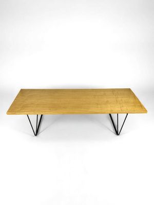 a wooden table with metal legs and a wooden top