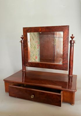 une petite coiffeuse en bois surmontée d'un miroir
