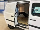 a white van with its doors open in a garage