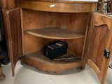 a corner cabinet in the corner of a room