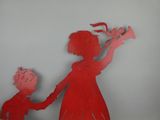 a red silhouette of a woman holding a child ' s hand