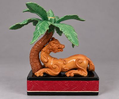 une figurine représentant un lion sous un palmier