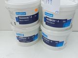 three buckets of paint sitting on top of a white table