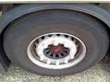 a close up of a truck tire with a red dot on it