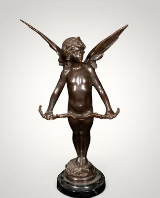 a bronze statue of an angel holding a piece of wood