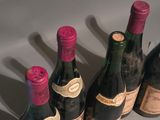 several bottles of wine are lined up in a row on a table