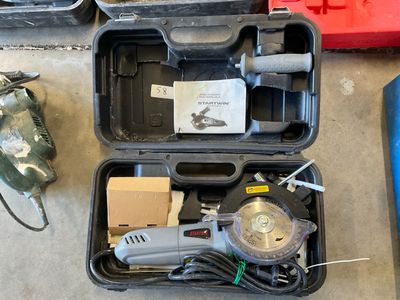 a tool box with tools in it sitting on the floor