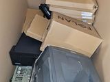a pile of electronic equipment in a cardboard box