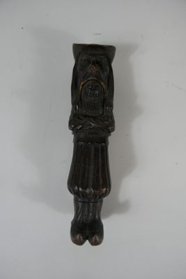 a wooden carving of a man with a hat on