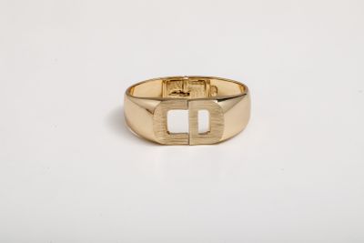 a close up of a gold ring on a white surface