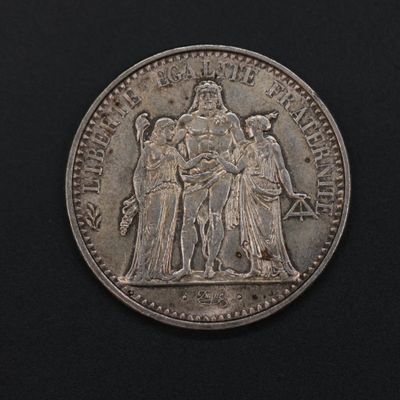 a silver coin with a picture of a man and a woman on it