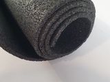 a roll of black felt sitting on a table