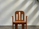 a wooden chair that is sitting in front of a stair