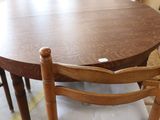a table and chairs in a store with a lot of furniture