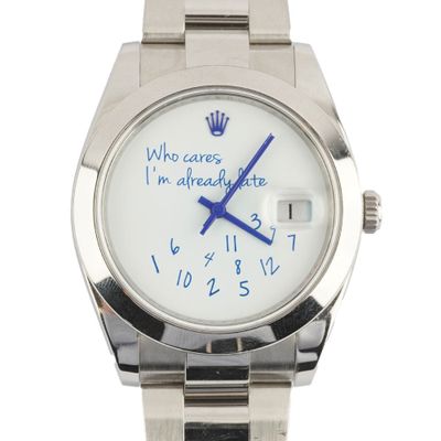 a wrist watch with a message written on it