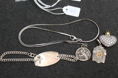 a silver necklace with charms on it on a black surface