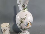 a vase and a cup sitting next to each other on a table