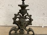 an old cast iron fire grate with a lion head on it