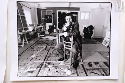 a black and white photo of a man sitting in a chair