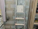 a ladder that is leaning against a wall in a room