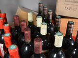 many bottles of wine that are sitting on a table