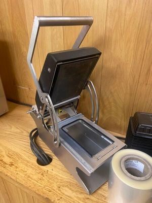 a machine that is sitting on a table with a roll of tape