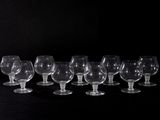 a lot of empty wine glasses on a black table