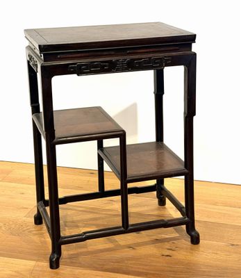 a small table with two stools on it on a hard wood floor