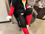 a mannequin sitting on a chair in front of a wall