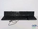 two keyboards sitting next to each other on a table