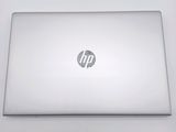 hp laptop computer sitting on a white surface with a logo on it