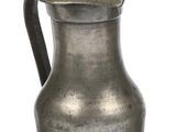 an antique silver pitcher with a bird on the handle