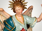 a figurine of an angel with a halo on his head