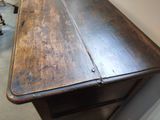 a wooden table with a drawer on top of it