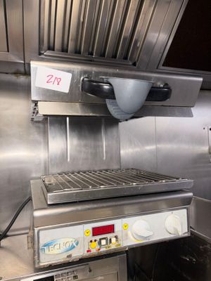a large metal grill in the middle of a kitchen