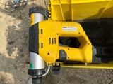 a yellow tool sitting on top of a yellow box